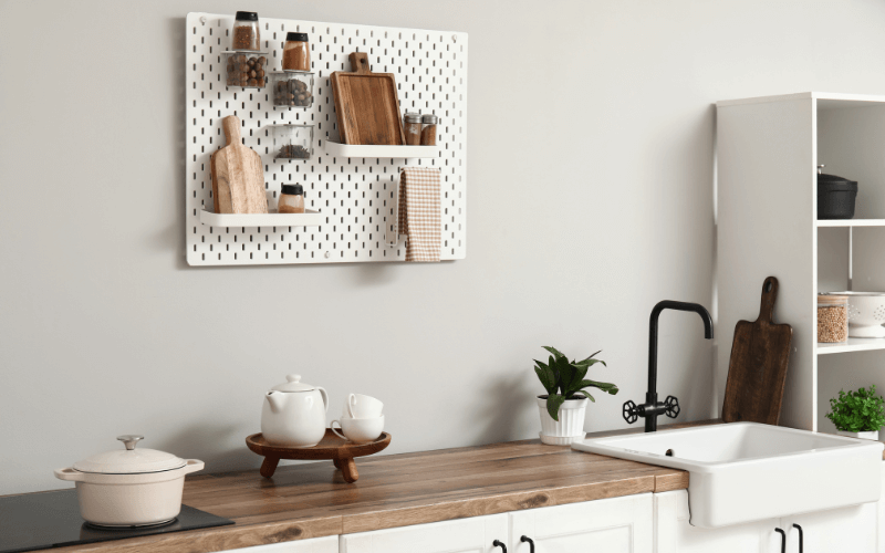 An image of a tall bookshelf or pegboard neatly organised on a wall.
