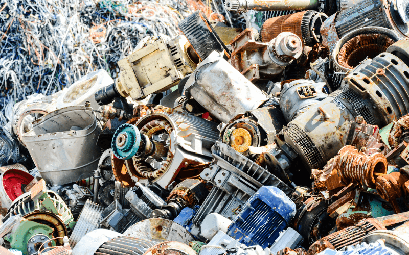 An image of hazardous waste items like batteries and paint cans at a designated disposal drop-off point.