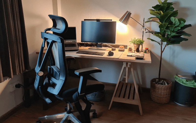 Image shot of an ergonomic office chair in an office space, a desk can be seen in the background but the main focus is the chair.