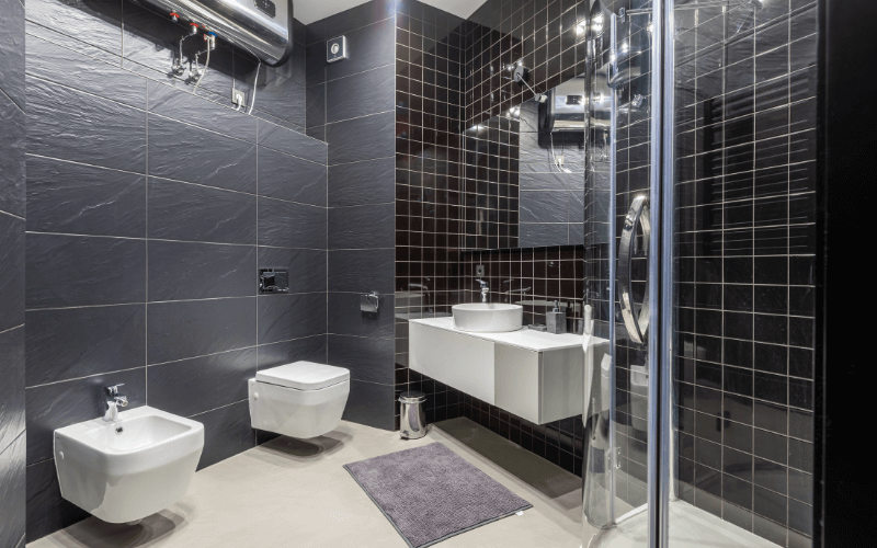 Image of ceramic bathroom wall tiles, is grey and has an interesting pattern.