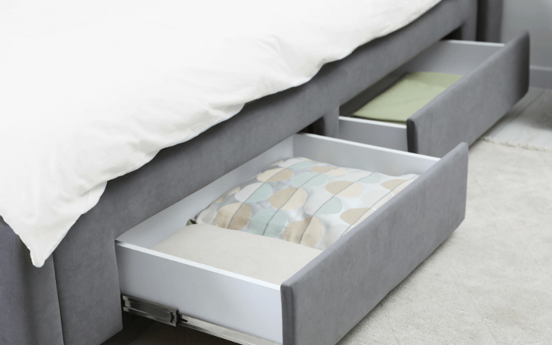 An image of a bed with built-in drawer