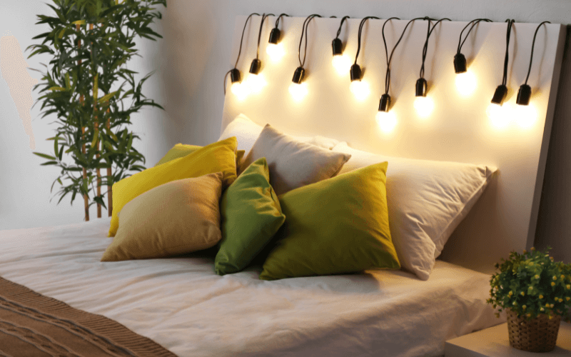 An image of a bed with fairy lights