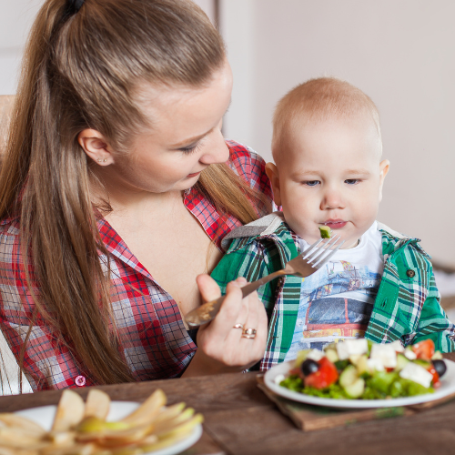 Image of a parent feeding their child healthy food