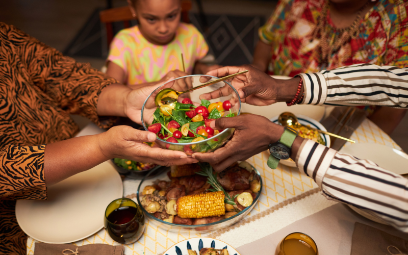 Image of a person passing out food and beverages to guests and friends