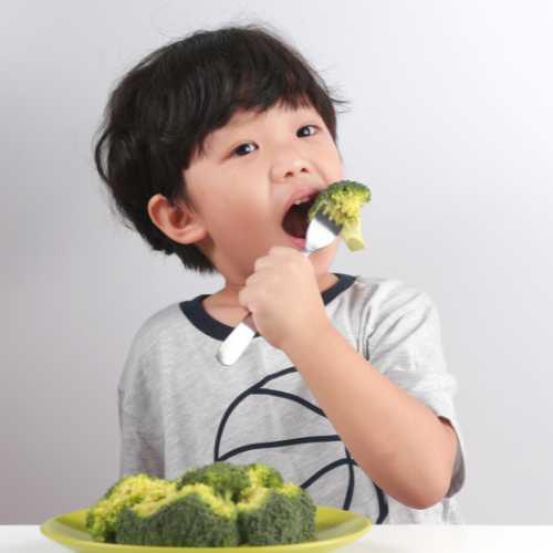 Small image of a child happily eating their vegetables