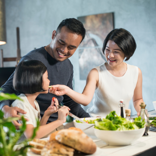 Small image of a parent and their kid eating healthy food