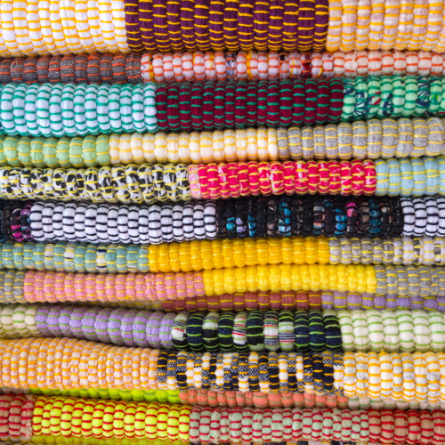 Small image of bright coloured rugs and artwork made in Singapore