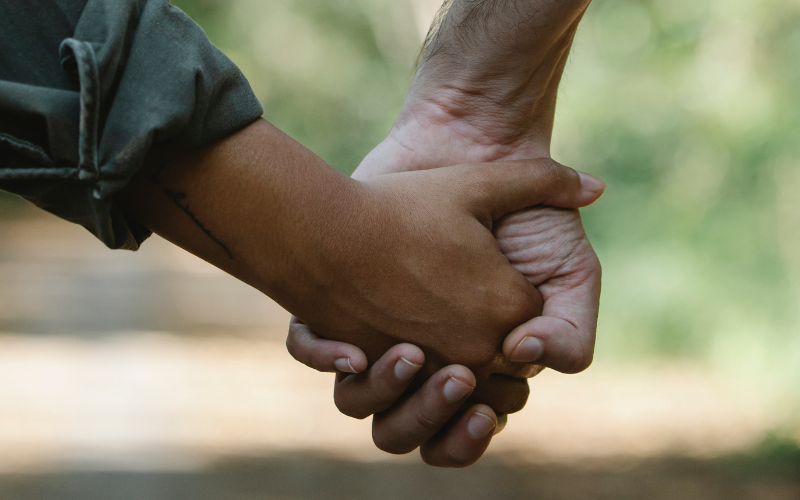 A couple holding hands on a walk