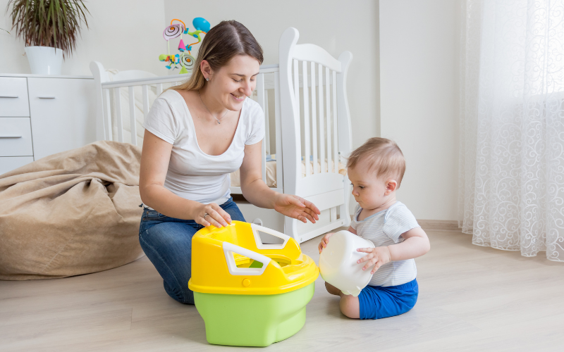 A parent showing a child how to use a pott