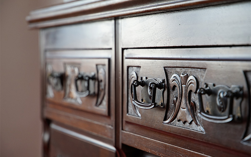 A wooden furniture with metallic finishes