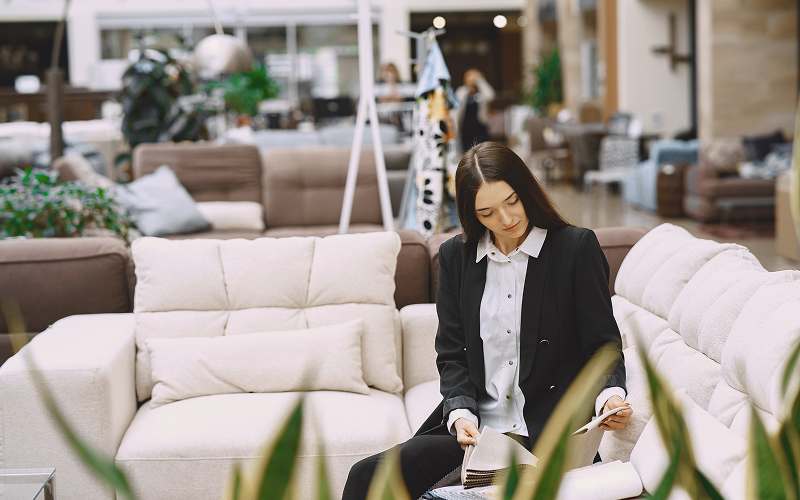 A person shopping in a furniture store.