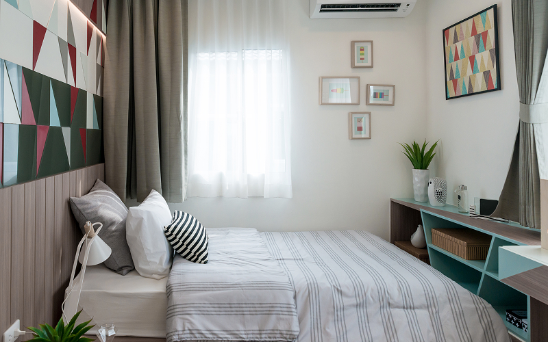 A stock photo of a compact bedroom.