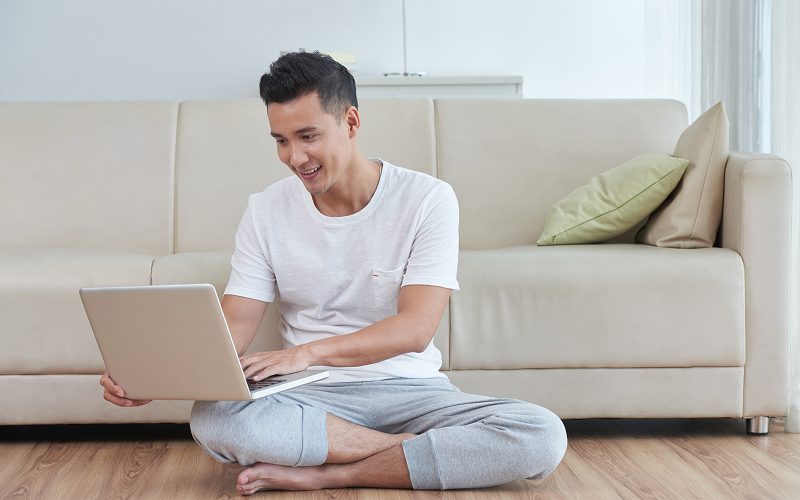A man surfing the internet using a laptop