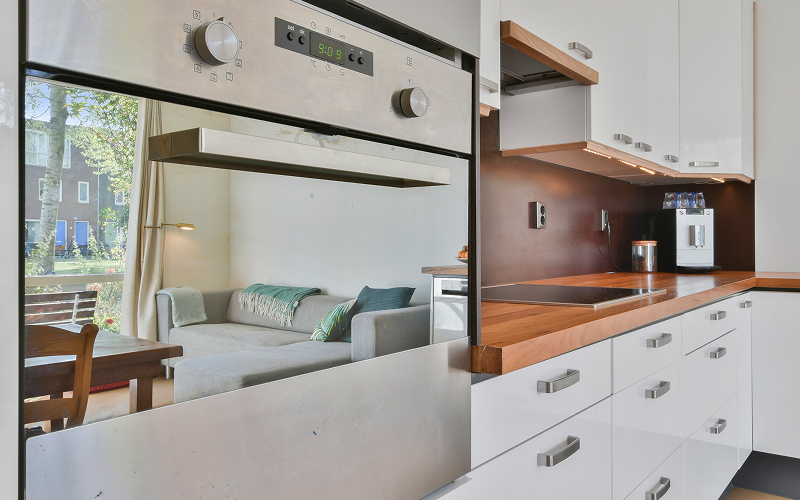 An image of a kitchen utilising corners with a cabinet/rack/or anything similar.