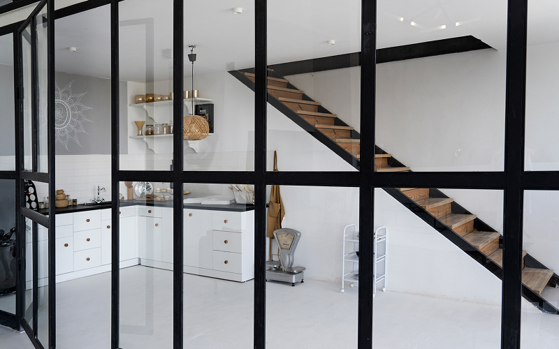 An image of a kitchen with glass partitions.