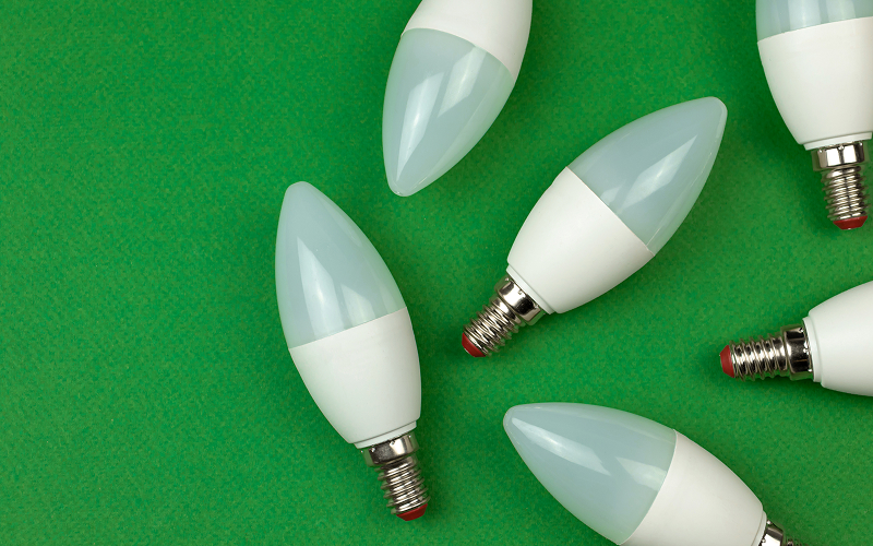 Close-up of LED bulbs beside an energy label with tick icons