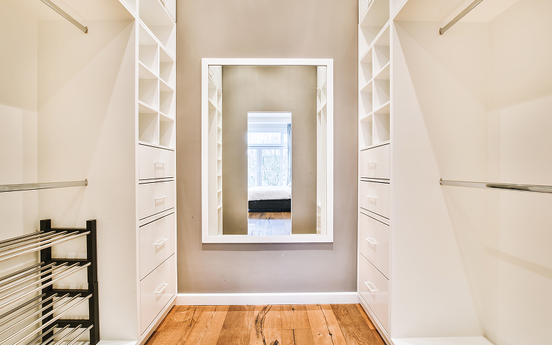 a mirror inside a walk-in wardrobe.