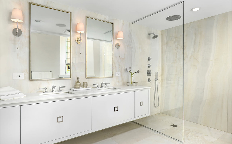 A light bathroom with a floating vanity and frameless glass shower