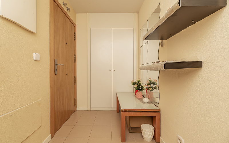A stock photo of an entryway with bench-storage.