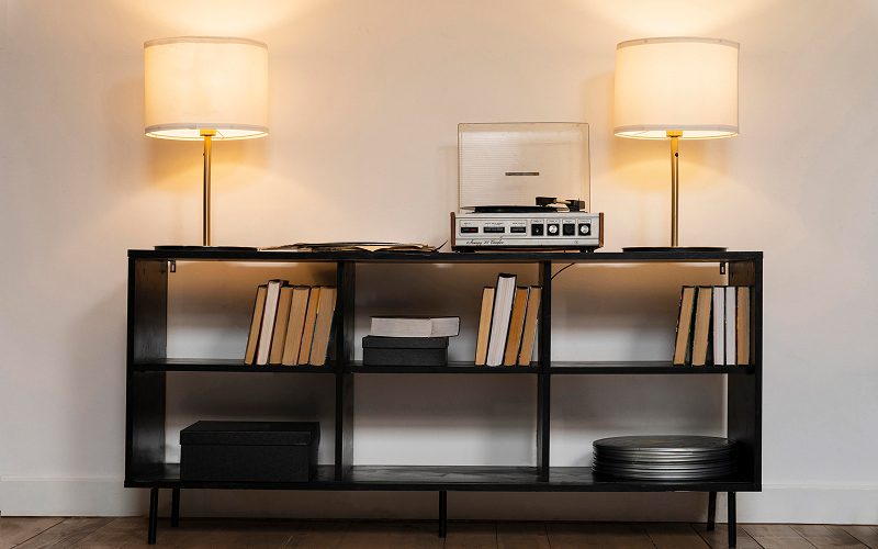 An image of a console table with books, vases, and metallic accents in an HDB setting.