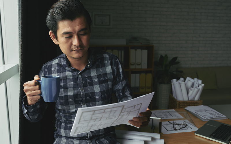 A person reviewing design plans