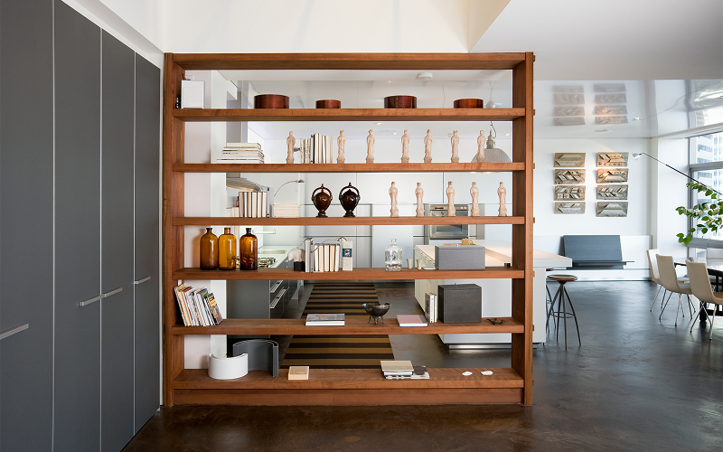 an open-shelf room divider in a room