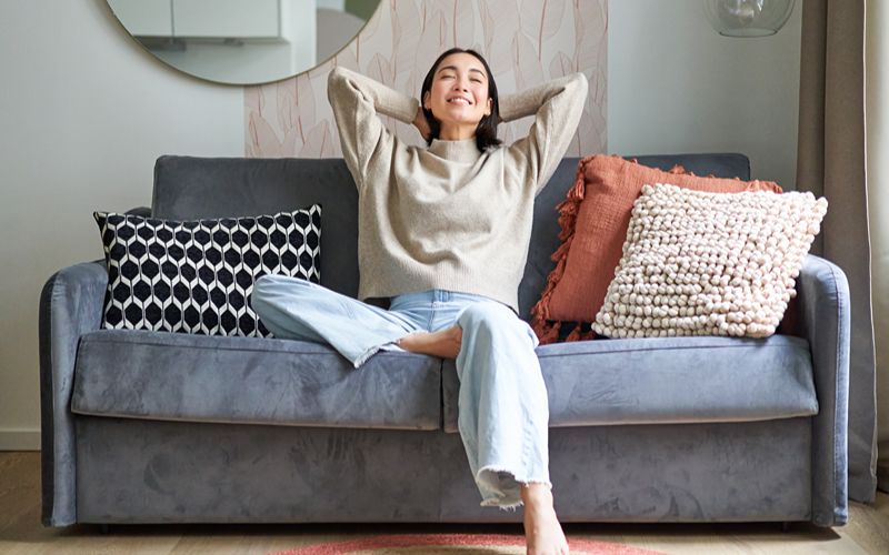 a person relaxing on a couch in a sophisticated modern living room
