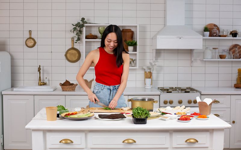 Image of a person preparing ingredients on a kitchen island