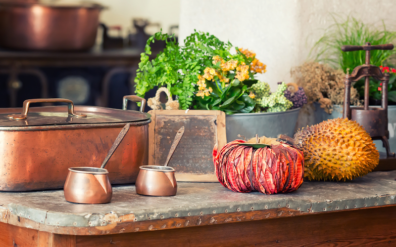a natural, patina-inspired kitchen with brass-colored kitchenware